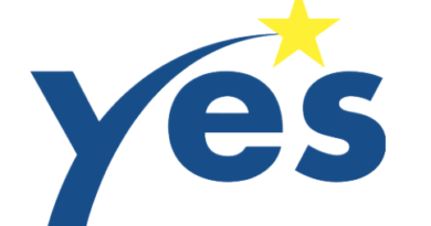 The logo of the Yes foundation, the word Yes with a star